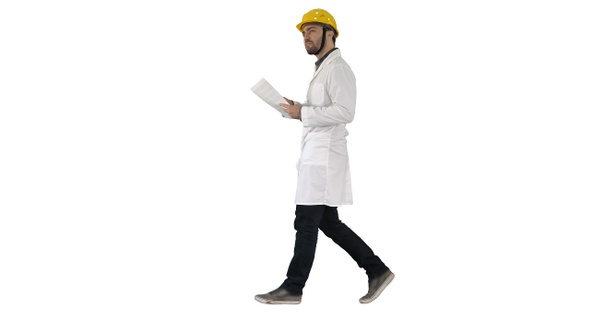 Engineer manager walking with hard hat is holding paper