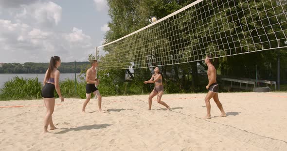 Friends in Motion Playing Voleyball at Lakeside
