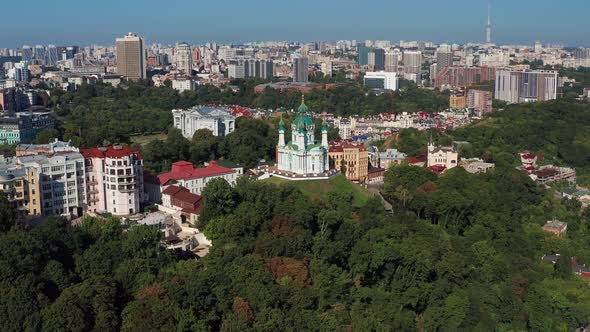 Beautiful flight over St. Andrew's Church in Kiev. Top view of Podol. Many buildings and churches.