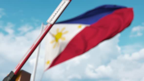 Barrier Gate with QUARANTINE Sign Being Closed at Flag of the Philippines alt