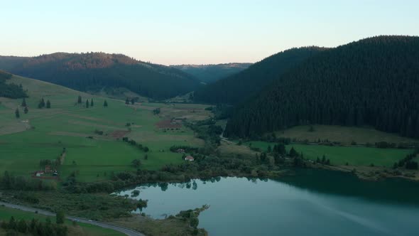 Green Mountain And Meadow Near Frumoasa Dam On The Frumoasa Brook In Romania. - aerial