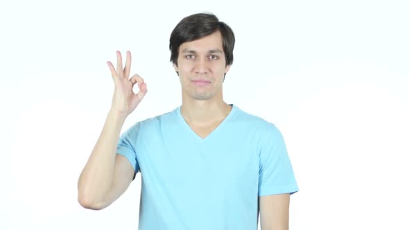 Okay Sign by Confident Young Casual Man, White Background