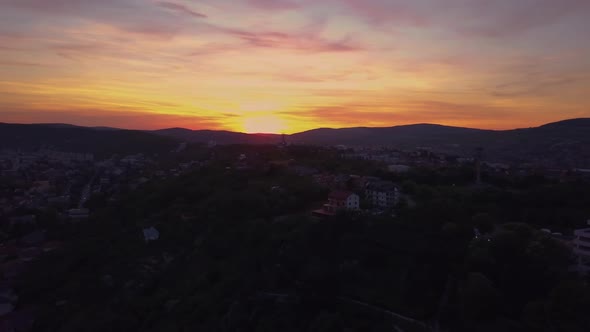 Sunset Red Skyline at Cluj, Romania, Transylvania. Aerial drone over European valley town city with