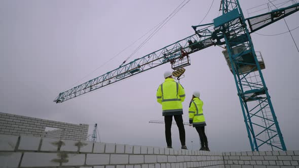 Building Inspector and Foreman in Construction Site Woman Inspector and Male Civil Engineer alt