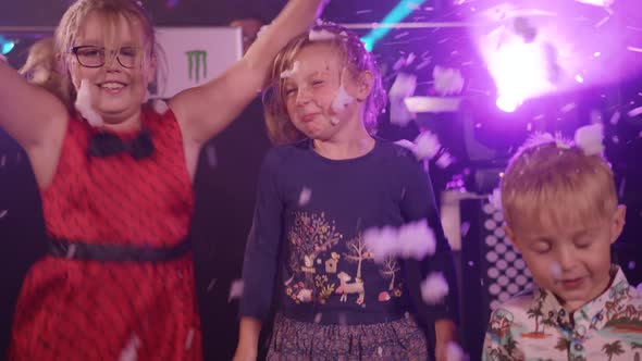 Kids Jump and Dance Whilst a Foam Machine Pumps Out Foam and Bubbles at Children's Party/Disco