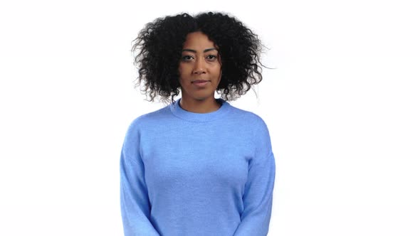 Pretty Mixed Race Woman with Curly Hair Looking to Camera Smiling