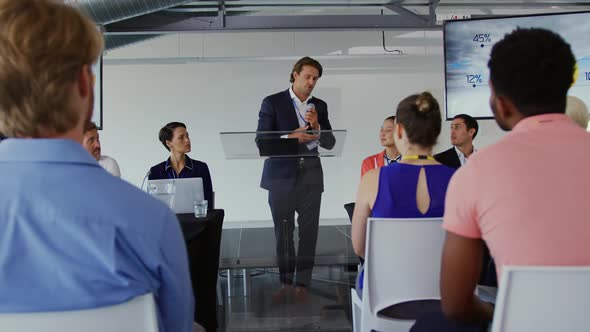 Male speaker addressing the audience at a business conference