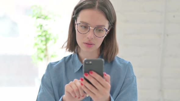 Young Woman Using Smartphone, Browsing