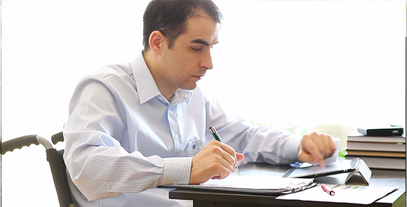 Office Worker in Wheelchair with Tablet Computer