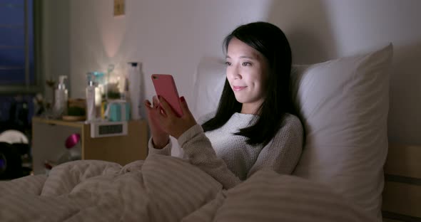 Woman use of smart phone at home in the evening