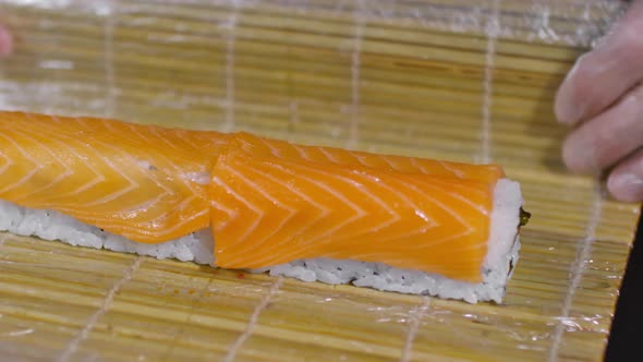 Professional Cook Preparing Sushi Rolls