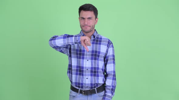Angry Young Hispanic Man Giving Thumbs Down