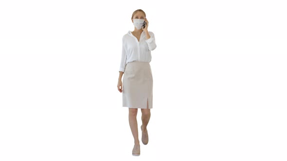 Young Woman Wearing Protective Face Mask Making a Call Walking on White Background