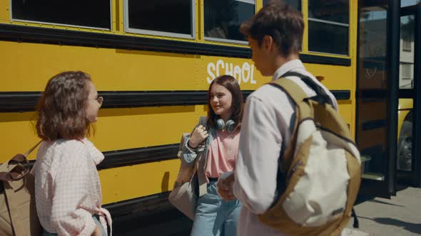 Cheerful Teen Classmates Chatting at School Bus