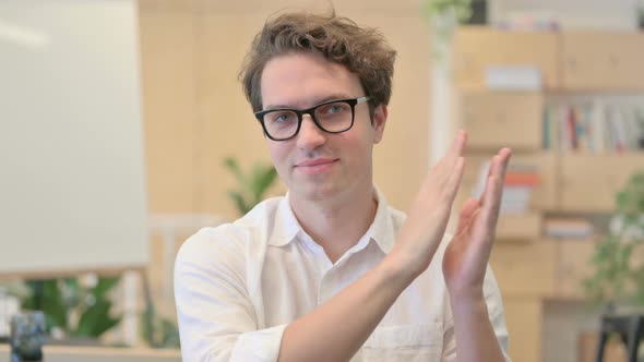 Portrait of Happy Young Man Clapping Applauding