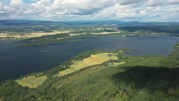 Picturesque Norwegian Fjord With Calm Lakedrain Between Lush Terrains In Norway - aerial drone