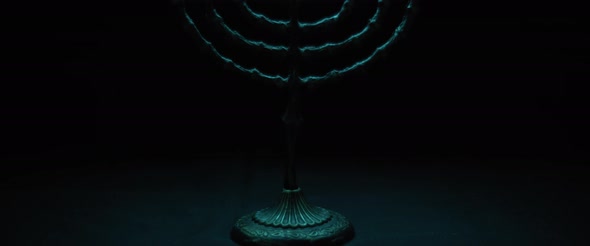 Hanukkah menorah candles in a dark room, slow motion