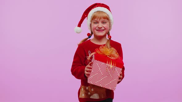 Cheerful Girl in Sweater Santa Christmas Getting Present Gift Box Expressing Amazement Happiness