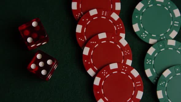 Rotating shot of poker cards and poker chips on a green felt surface - POKER 048