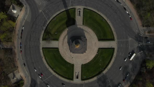 AERIAL: Overhead Birds Eye Drone View Rising Over Berlin Victory Column Roundabout with Little Car