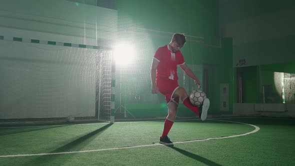 Slow Motion Professional Football Player Performs Tricks with a Soccer Ball Balances and Throws the