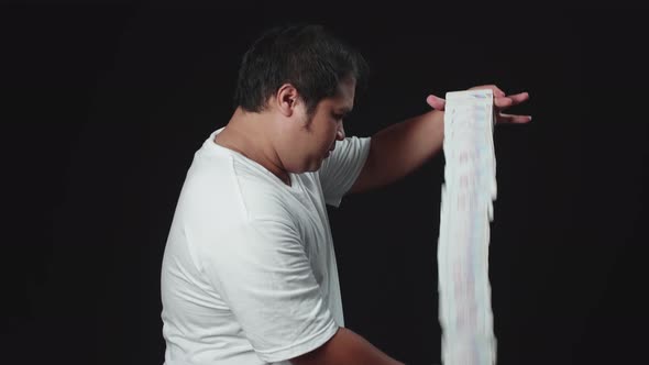 Asian Magician Starts Showing His Trick With Cards, Cards Cascading Down