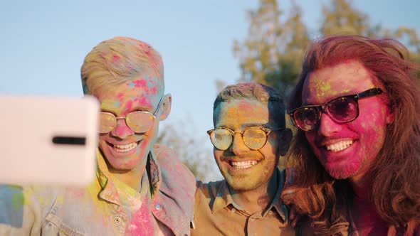 Slow Motion of Cheerful Guys Multiethnic Friends Taking Selfie at Holi Festival
