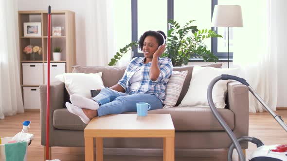 Woman in Headphones Resting After Home Cleaning 32