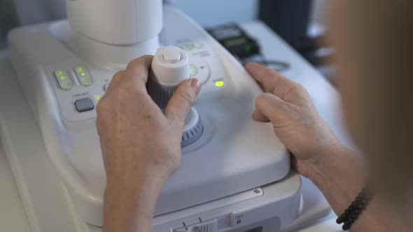 Optician Examines Patient With Camera Retina Scanner Close Up Shot Of Control Unit