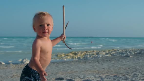 Happy Baby Boy Relaxing at Seashore