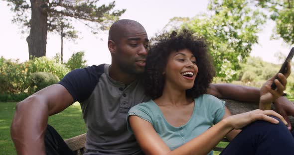 Happy mixed race couple enjoying in the garden during a sunny day