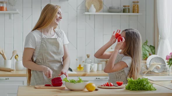 Adult Mother Housewife Cuts Red Pepper Vegetable Ingredient Salad Daughter Child Teen Girl Helps Mom