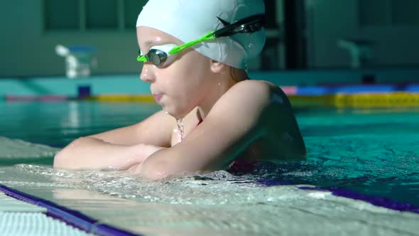 Handsome Young Girl Emerges From Under Water in the Swimming Pool.