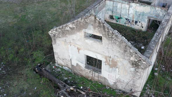 Roofless derelict building abandoned after hurricane: walls of demolished and dilapidated house