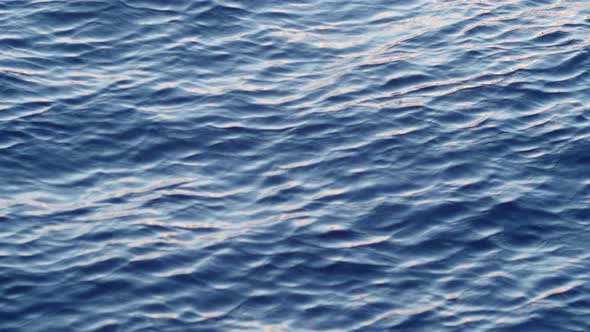 the Surface of the Blue Water Water Slowly Moves on the Sun Waves of Sea Ocean or Lake in Slow