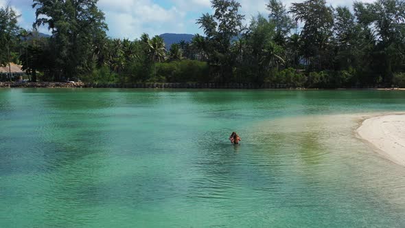 Emerald calm waters in the Thailand lagoon. Girls enjoying summer vacation on tropical island Koh Ph
