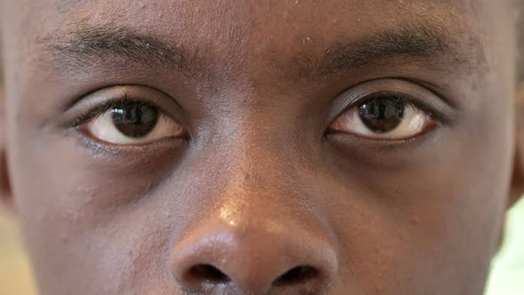 Close Up of Blinking Eyes of Young Young African Man