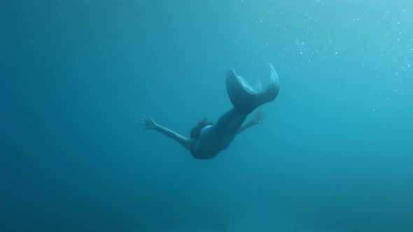 Mermaid in the depths of the ocean water