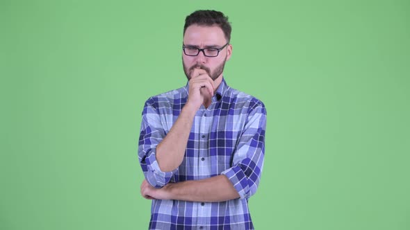 Stressed Young Bearded Hipster Man Thinking and Looking Down