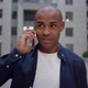 Ethnic Man Answering Phone Call on Street - VideoHive Item for Sale