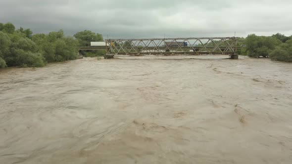 Aerial View of the Bridge During Floods. Extremely High Water Level in the River.