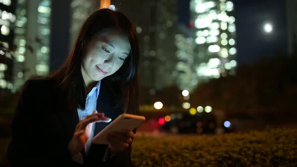 Businesswoman sending sms on cellphone at Tokyo city