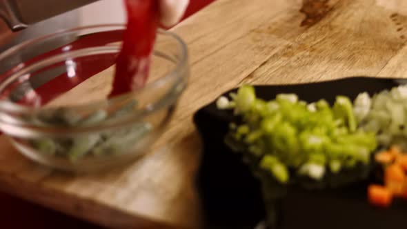 Hands of a Woman Peeling Frozen Red Bell Pepper on the Wooden Cutting Board