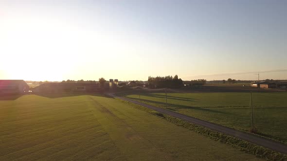 Aerial Cinematic Clip Drone Flying Over a Farm Field During Sunset