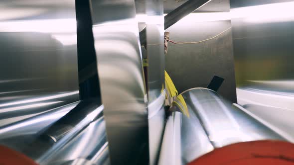 Engineer with Laptop Moving Behind Rolling Mill