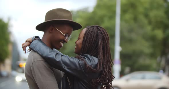 Affectionate Young African Couple Embracing Standing Together on Street in City