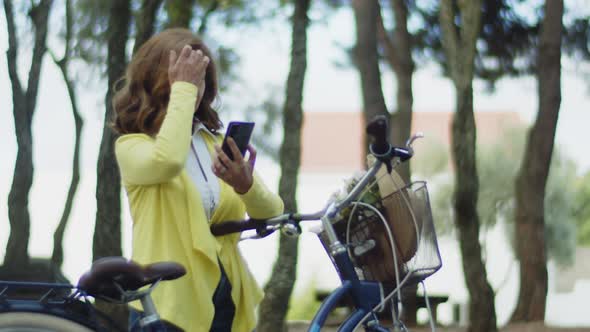 Medium Shot of Senior Woman Finding Route in Summer Park