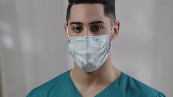 Close Up Male Face Hispanic Arab Man Doctor Nurse in Safety Medical Mask Confident Looking at Camera