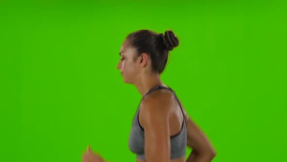 Woman Running in Sport Clothing. Side View. Green Screen