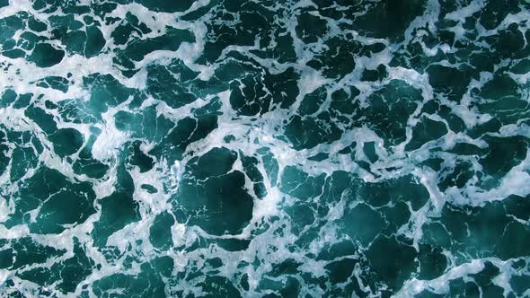 Close up birds eye view footage of deep blue ocean white wash in hawaii